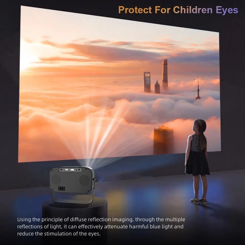Black portable smart projector with remote control and cables on desk