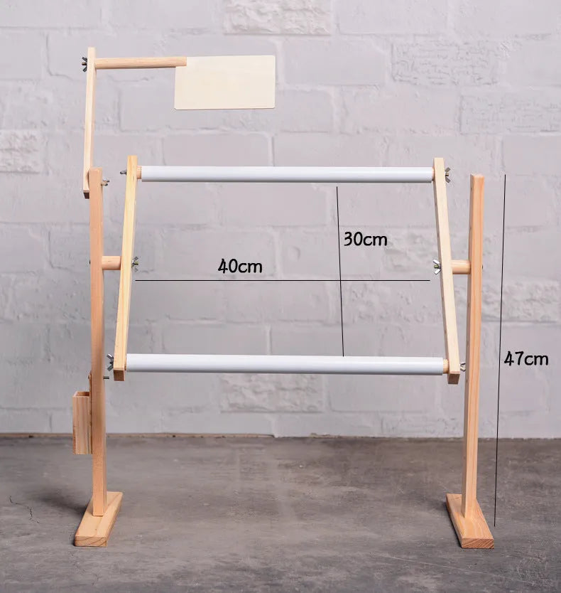 Vertical solid pine wood desktop embroidery frame with height adjustment mechanism in a natural log colour.