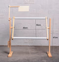 Vertical solid pine wood desktop embroidery frame with height adjustment mechanism in a natural log colour.