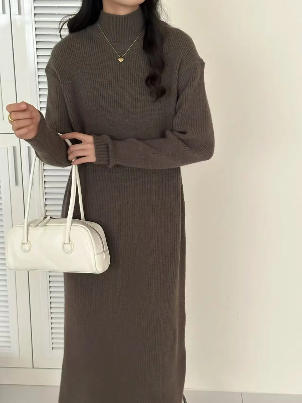 Half turtleneck knitted dress in graphite colour, knee-length with long sleeves and a high waist.