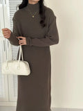 Half turtleneck knitted dress in graphite colour, knee-length with long sleeves and a high waist.