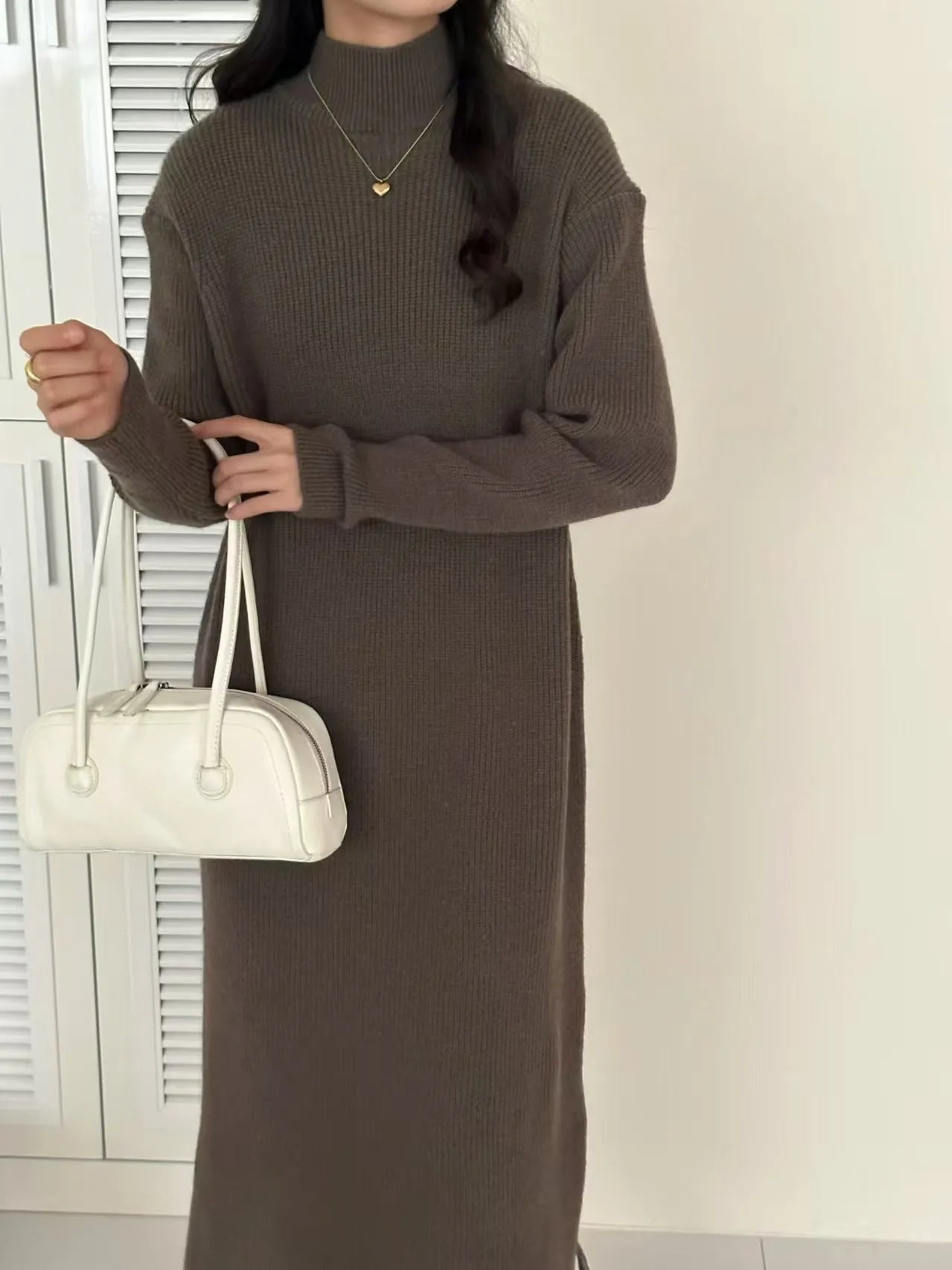 Half turtleneck knitted dress in graphite colour, knee-length with long sleeves and a high waist.