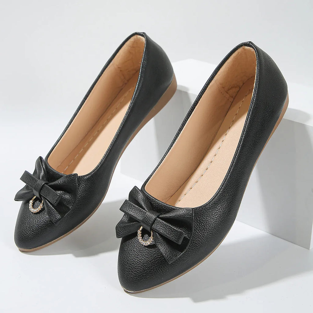 Women's beige casual flat shoes with a bowknot detail, shallow mouth, round toe, and flat rubber sole.