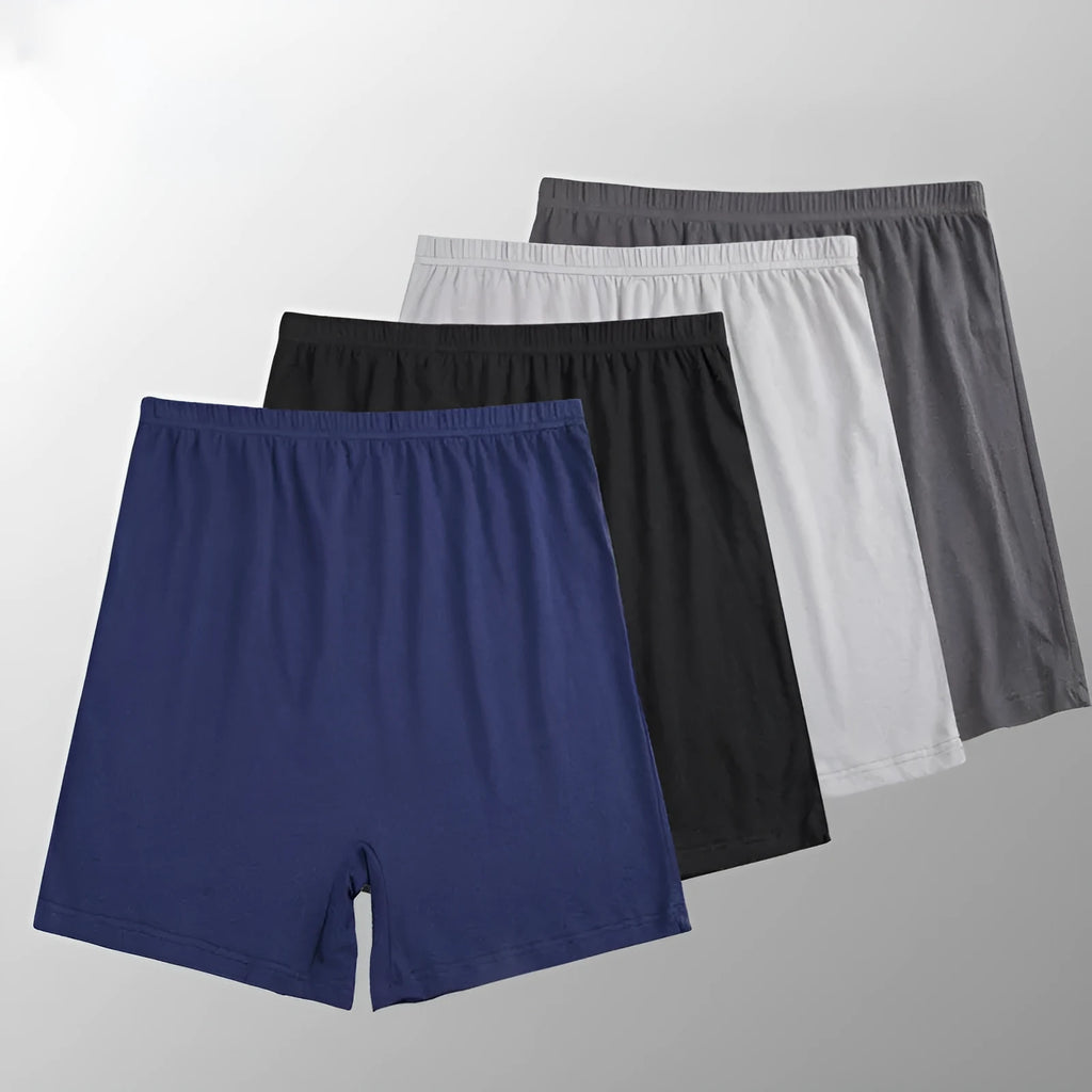 Man holding a pair of solid colour high-waist modal boxer shorts in dark grey.
