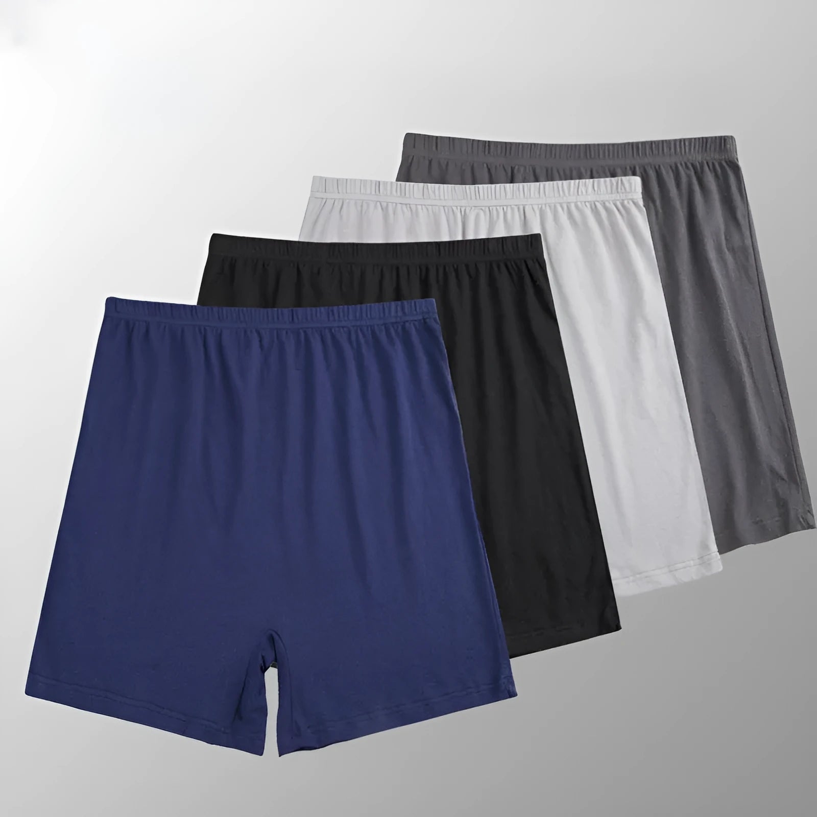 Man holding a pair of solid colour high-waist modal boxer shorts in dark grey.
