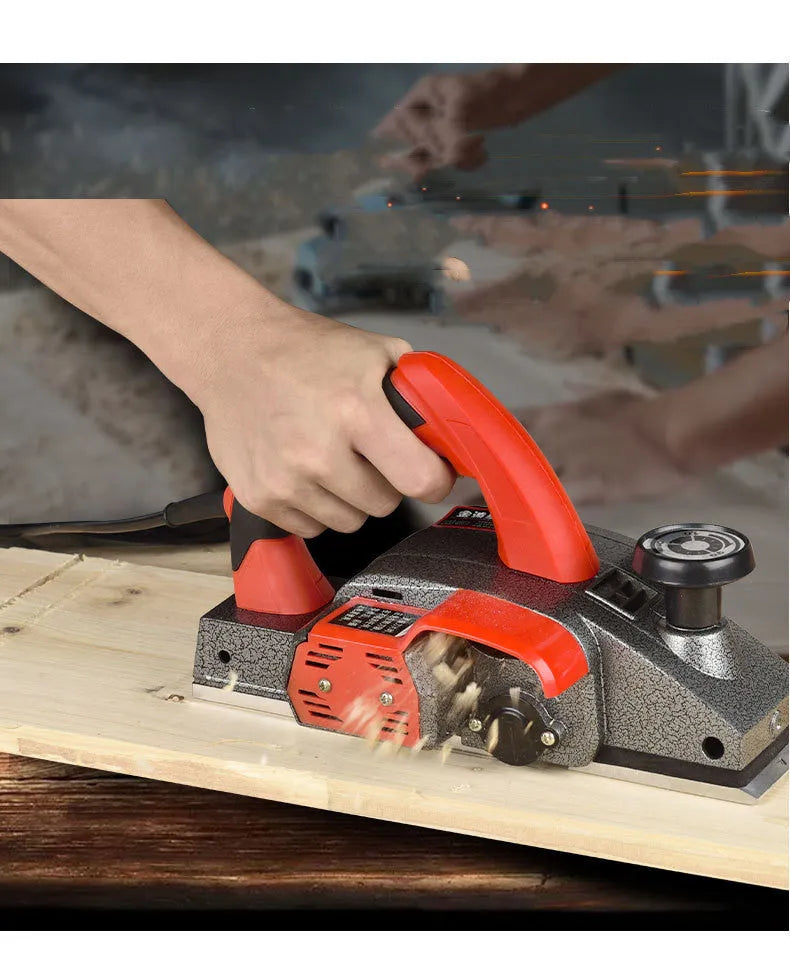 Red electric wood planer tool with aluminum shell showing 82mm planing width measurement