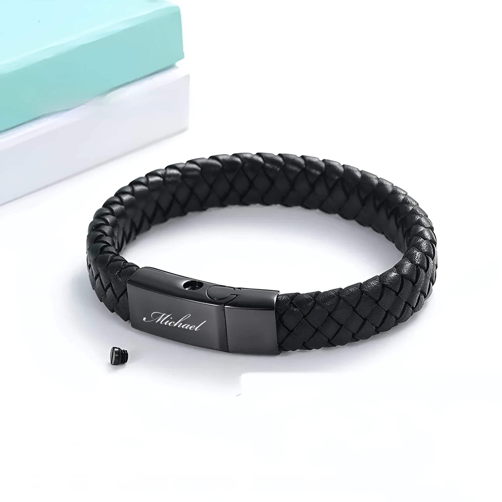 Black leather cord bracelet with woven stainless steel casket pendant.