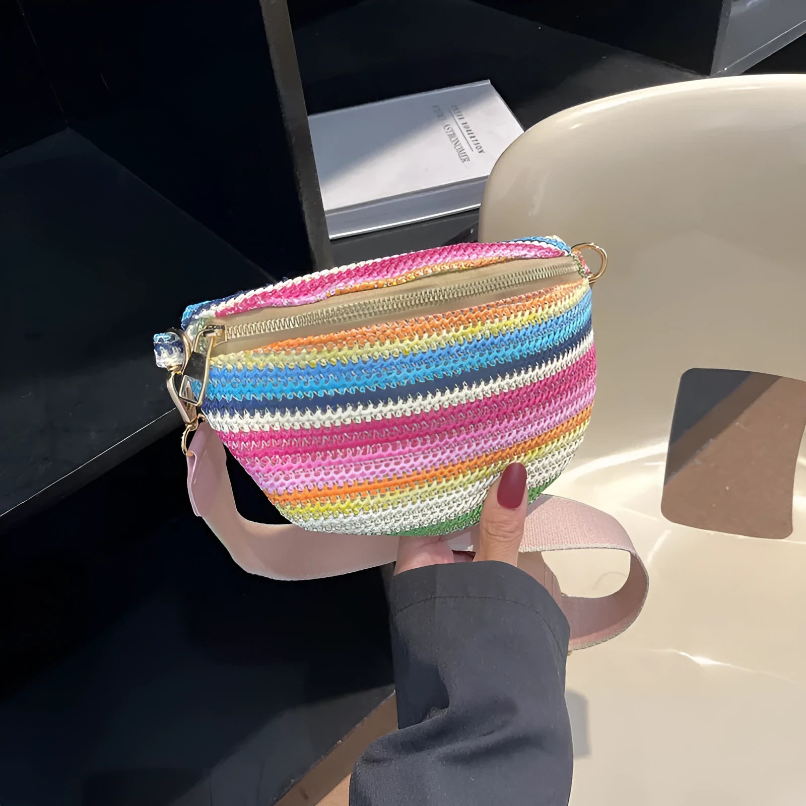 Bohemian style straw beach bag for women in shell shape with single strap and zipper closure available in pink or blue
