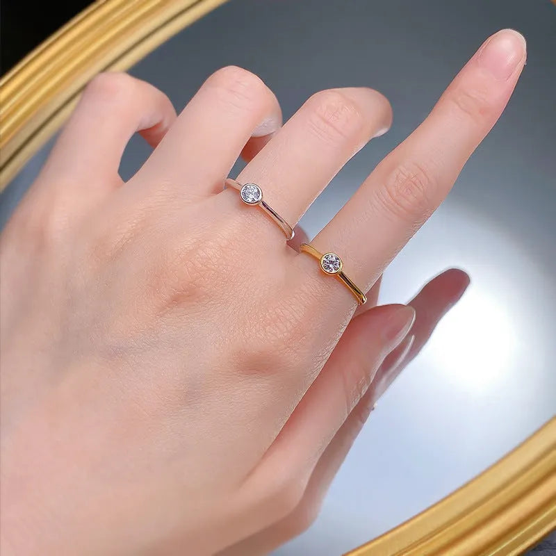 Minimalist silver crown-shaped ring with linear details, shown in gold and platinum finishes.