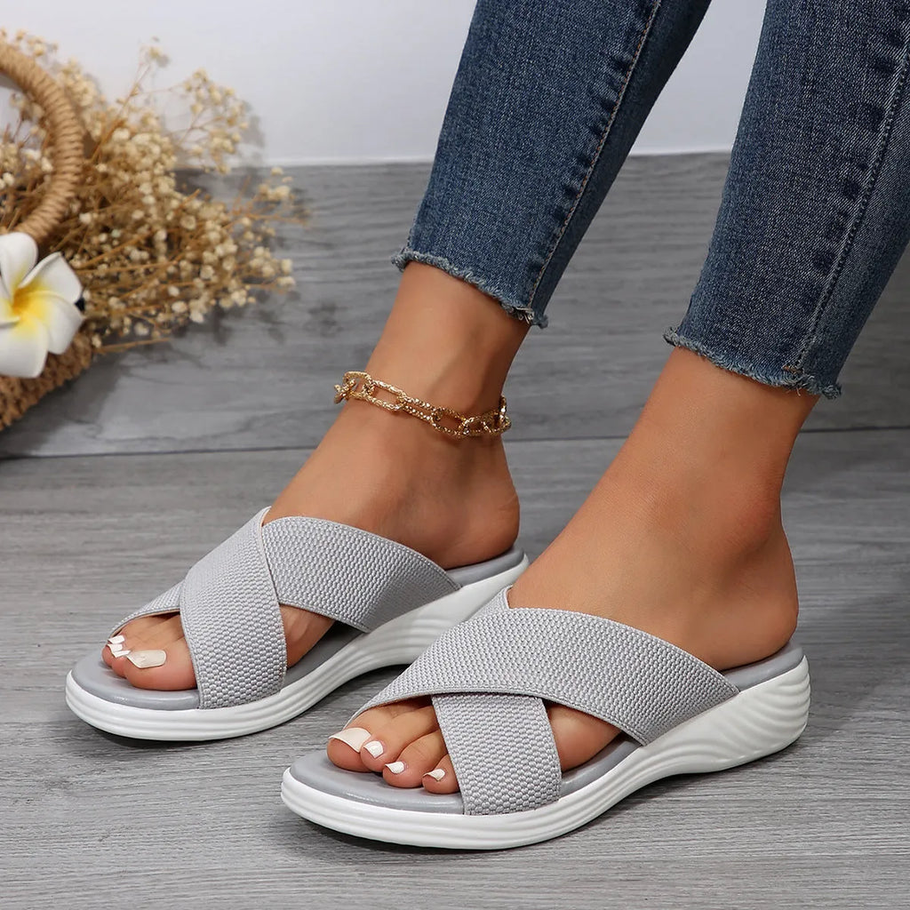 Black wedge slippers with peep-toe opening and thick rubber sole