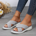 Black wedge slippers with peep-toe opening and thick rubber sole