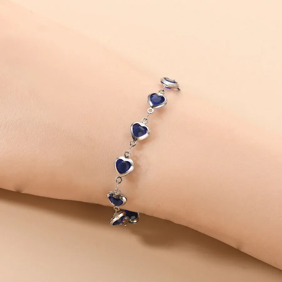 Devil's Eye geometric heart bracelet in stainless steel, shown in colourful, blue, green, or red electroplated finish