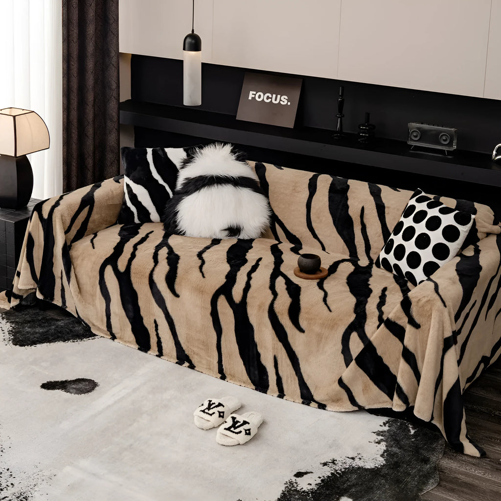Zebra pattern flannel sofa cover with non-slip properties in caramel colour on a sofa