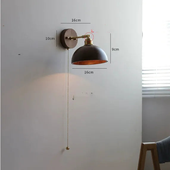 Nordic style wooden bedside wall lamp in walnut colour mounted on a wall.