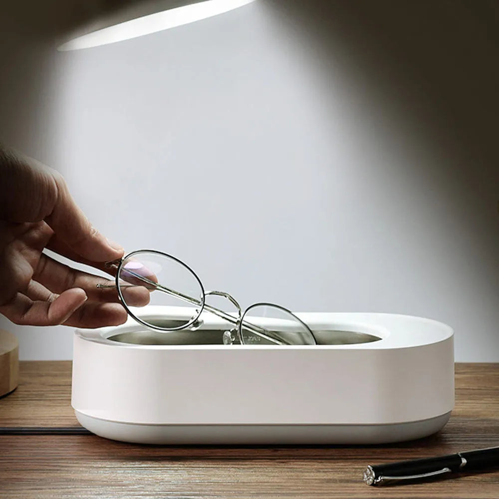 White portable ultrasonic cleaning machine with digital display and stainless steel tank.
