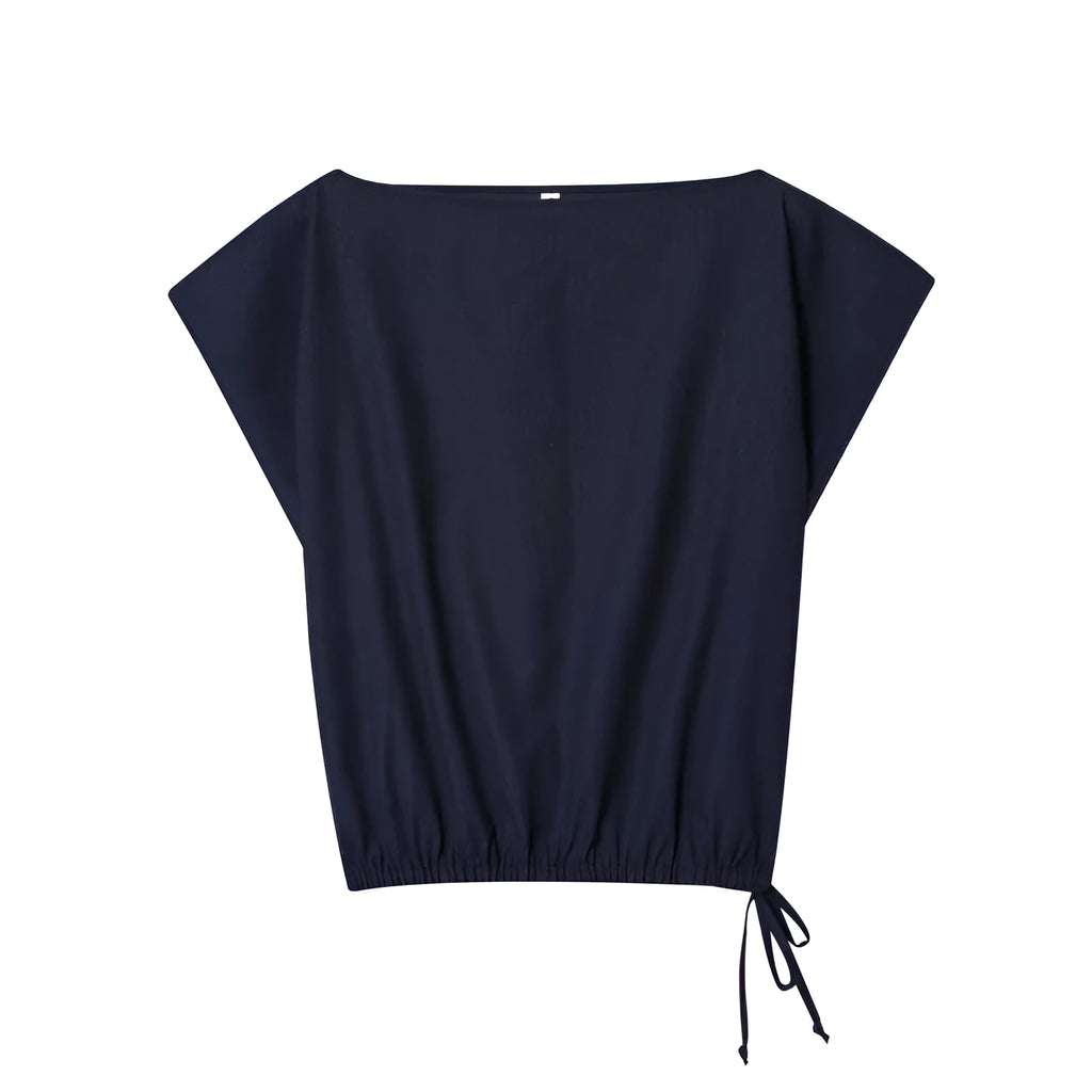 Women's beige linen-look shirt with flounced sleeves and matching wide-leg trousers on a hanger.