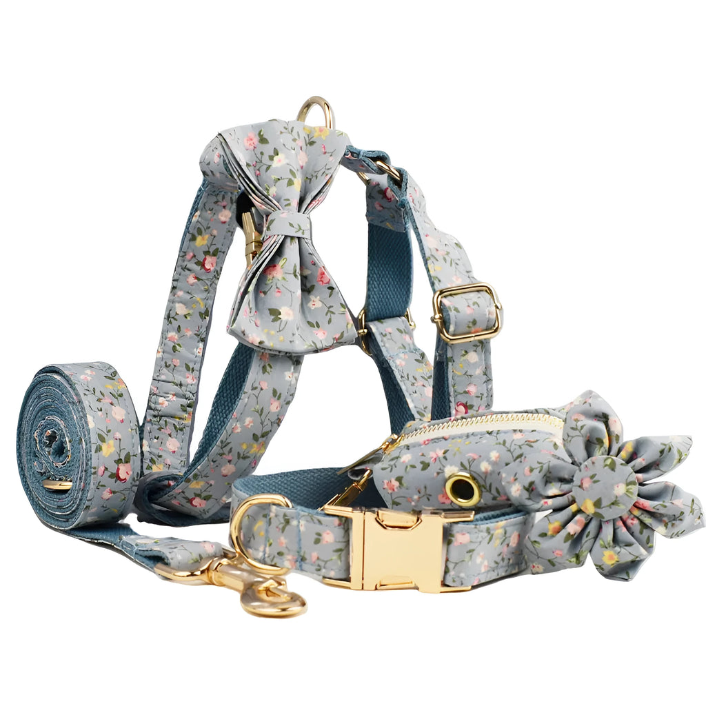 Blue floral pattern dog collar accessories set with adjustable collar, matching leash, bow, vest, and poop bag