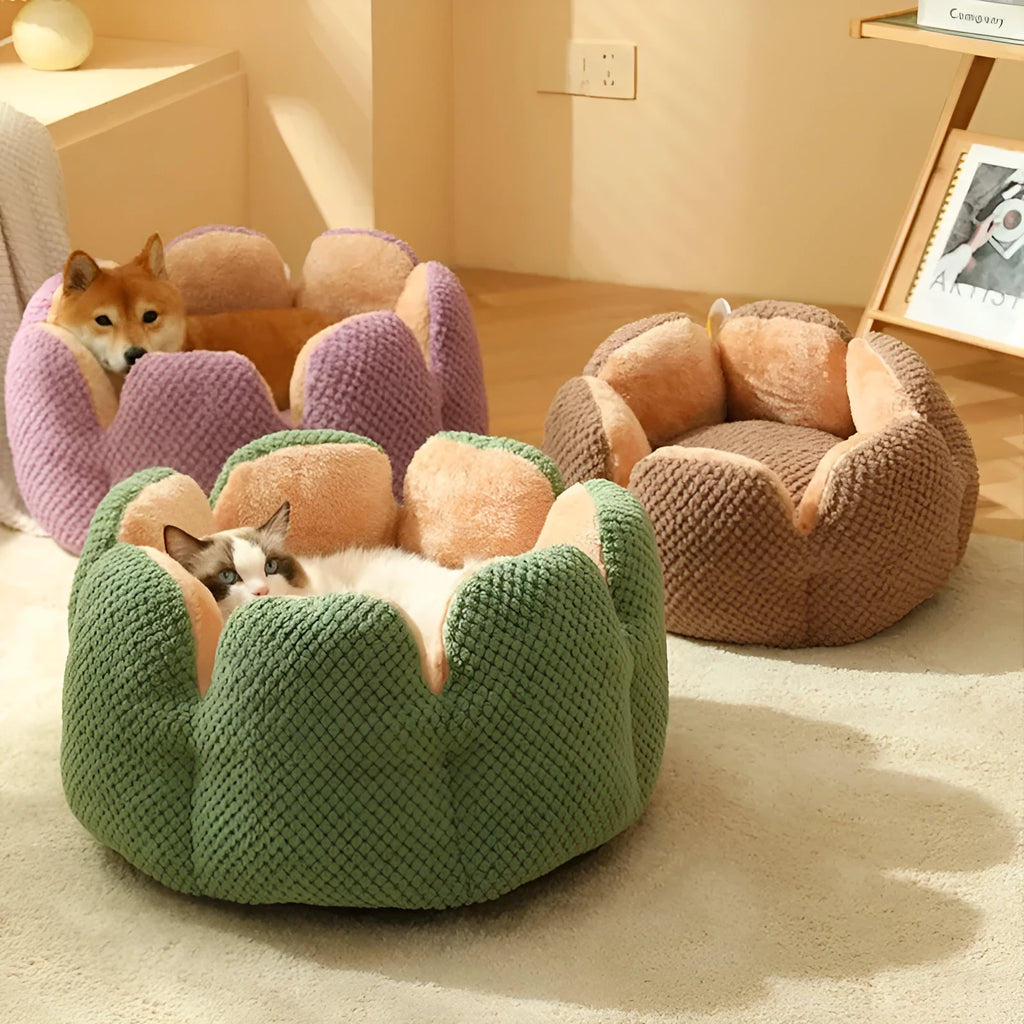 Grey petal-shaped plush kennel bed for cats and dogs on a hardwood floor.
