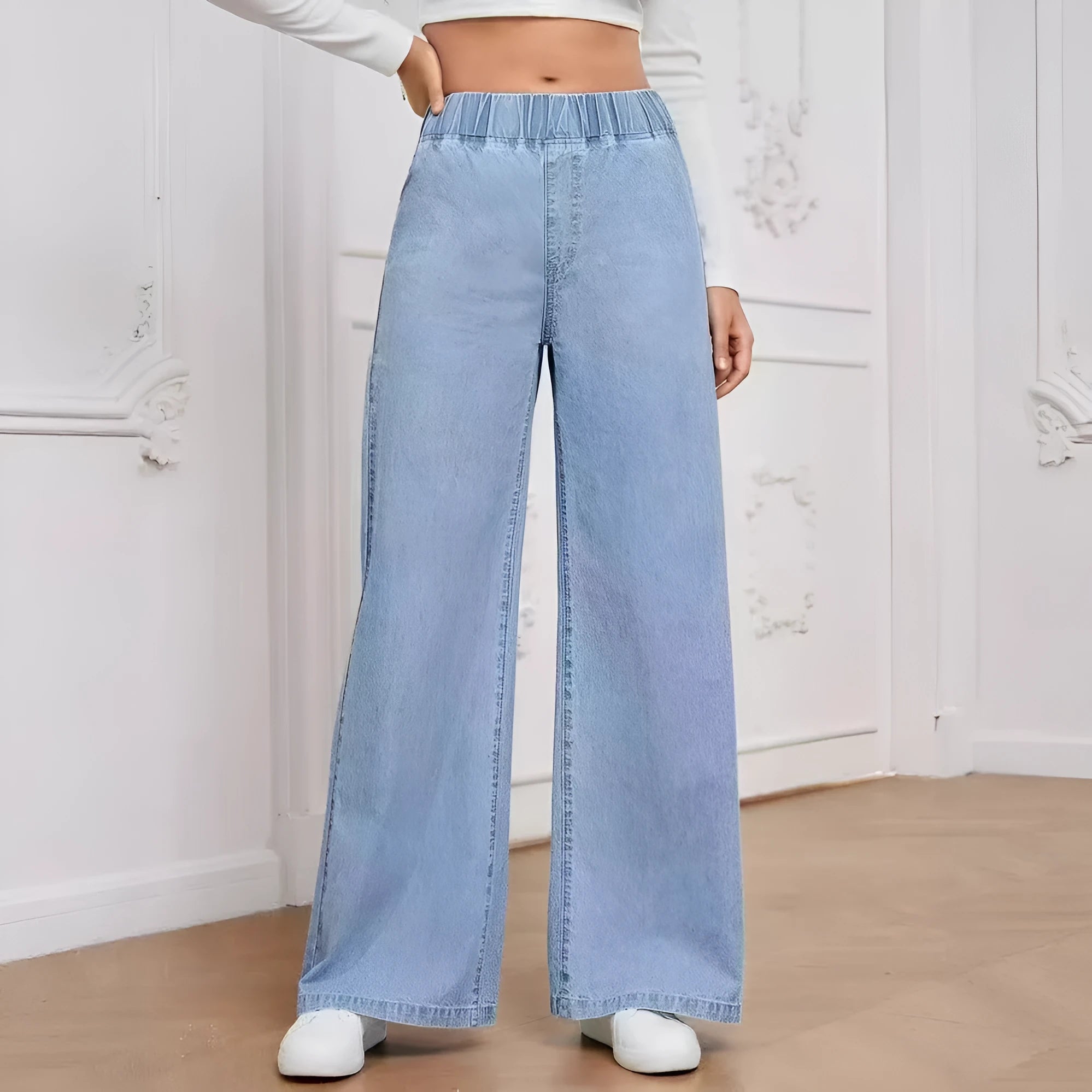 Light blue washed wide-leg jeans on a hanger, showing the straight-leg silhouette and mid-waist design.