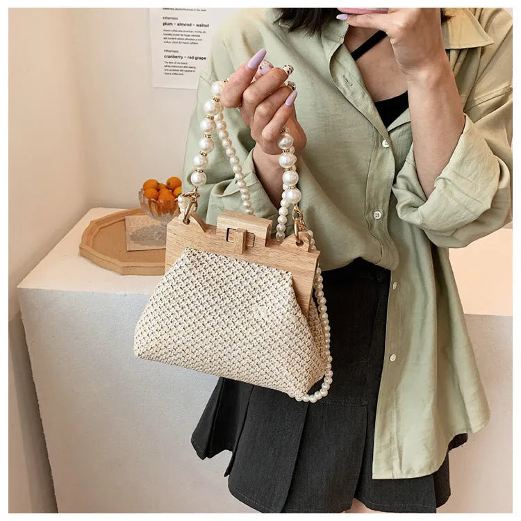 Women's straw shoulder bag with pearl chain detail in horizontal square shape