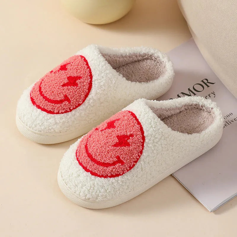 Women's plush home slippers in cartoon love style print with round toe and non-slip PVC sole.