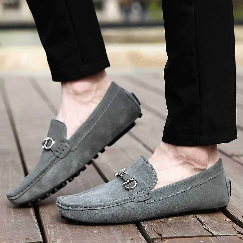 Men's black matte cowhide leather slip-on loafers with a square toe and flat rubber sole.