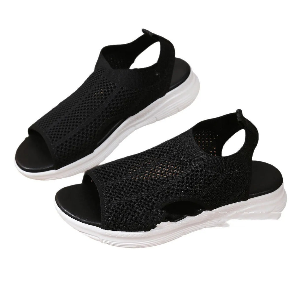 Women's flat black platform sports sandals with mesh lining and a thick rubber sole.