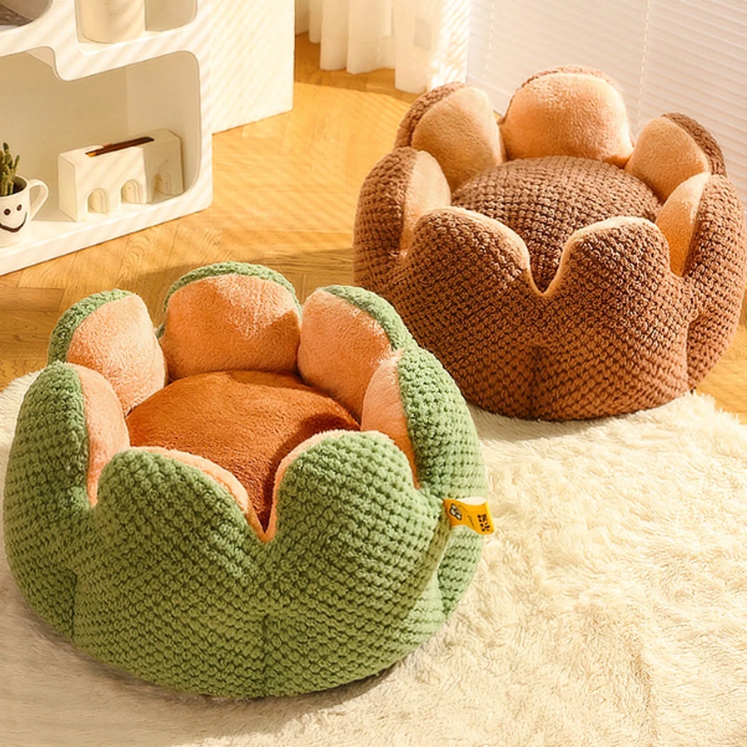Grey petal-shaped plush kennel bed for cats and dogs on a hardwood floor.