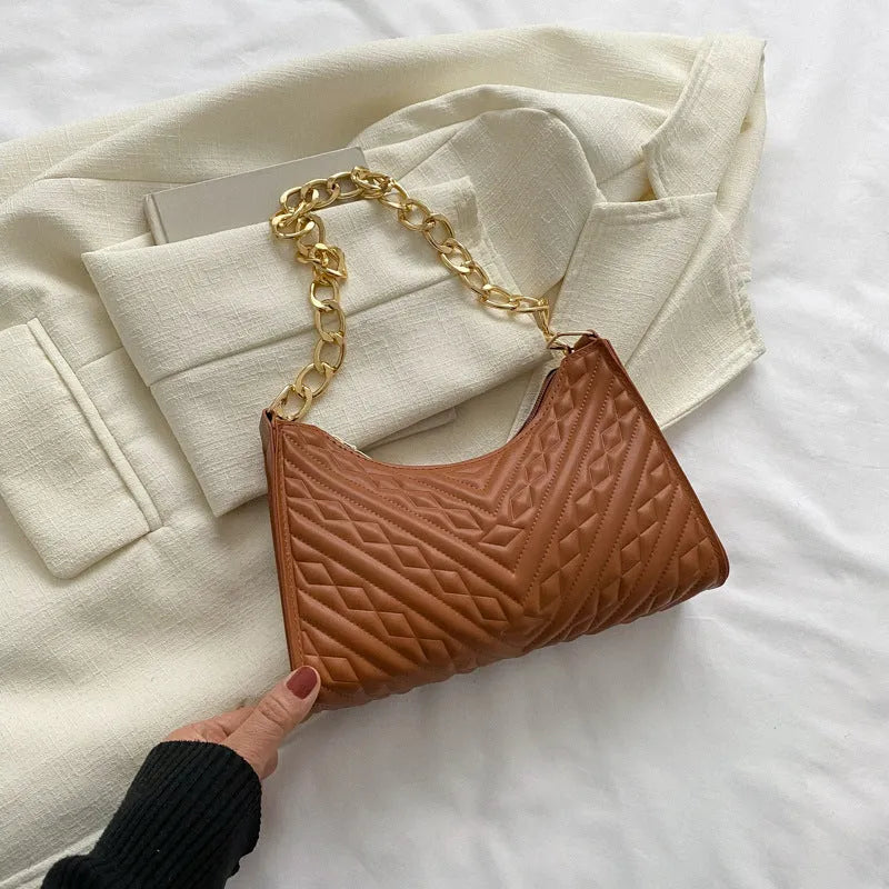 Brown pleated PU leather baguette bag with a gold-tone chain shoulder strap and a soft top handle.