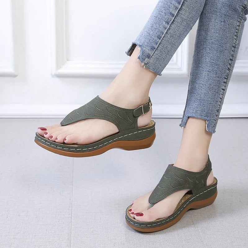 Women's casual wedge-heel sandals with adjustable buckle strap in a solid colour.