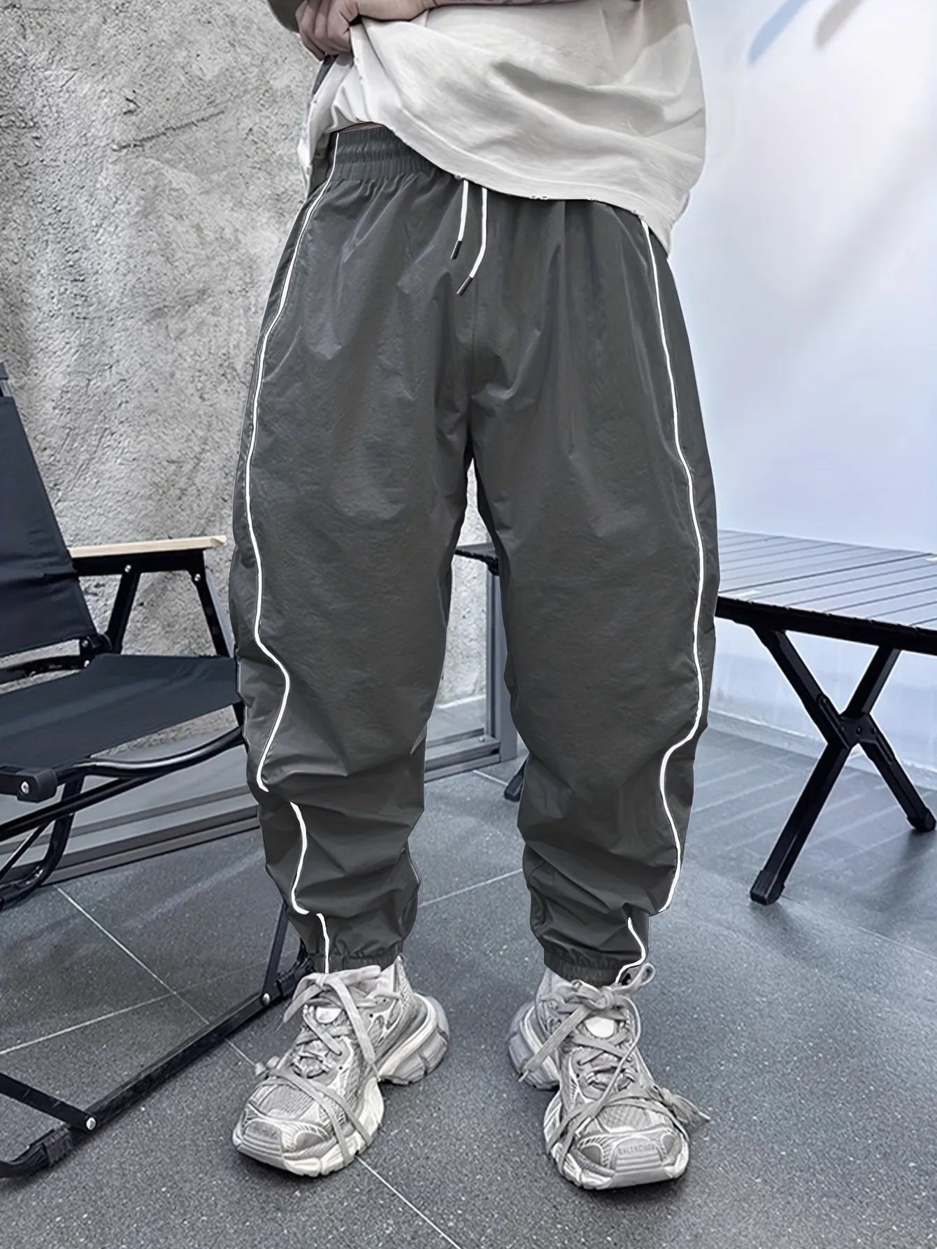 Men's blue bamboo fibre sports trousers with a loose, cropped fit and elastic waist.