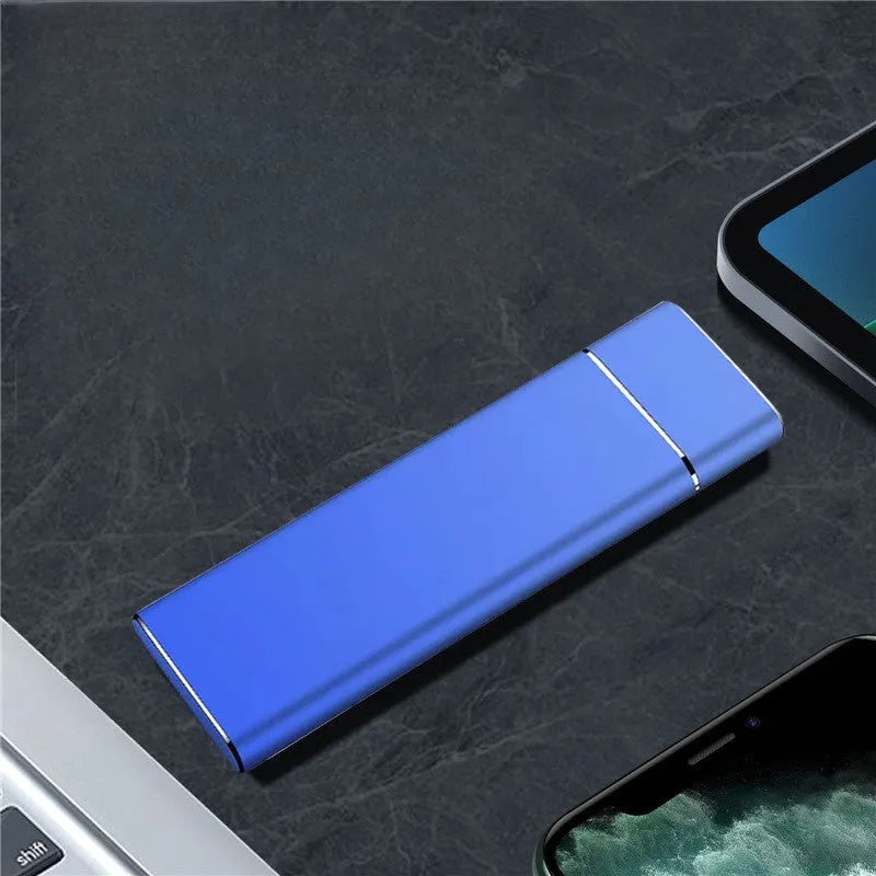 Sapphire blue metal portable solid state external hard drive with USB cable on a white background.