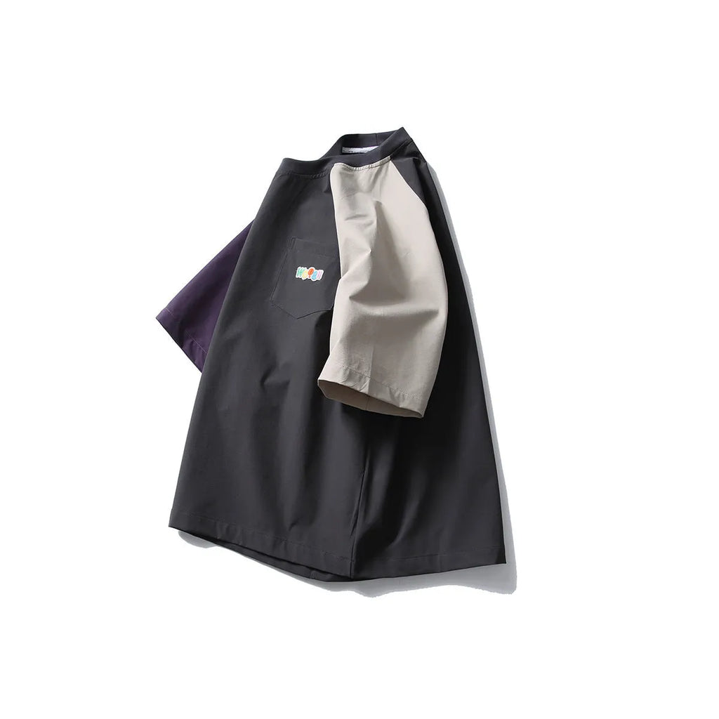 Dark grey men's loose fit t-shirt with light coloured contrast raglan sleeves.