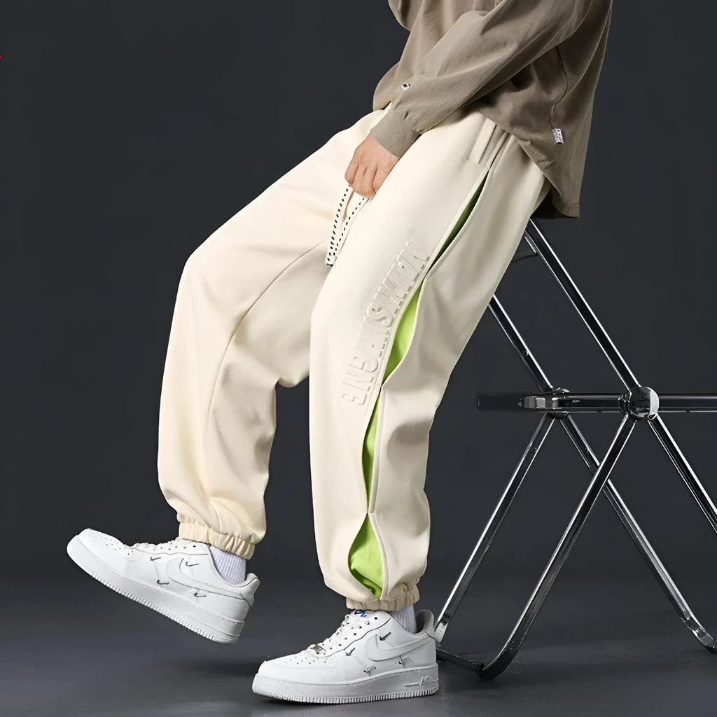 Men's loose cotton trousers with stitching printing design and ankle banded cuffs in black colour