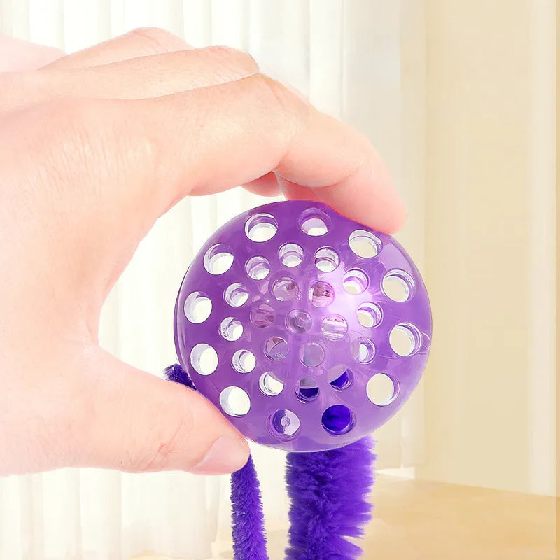 Interactive worm-shaped bouncy ball cat toy with tail in green, pink, or purple colours