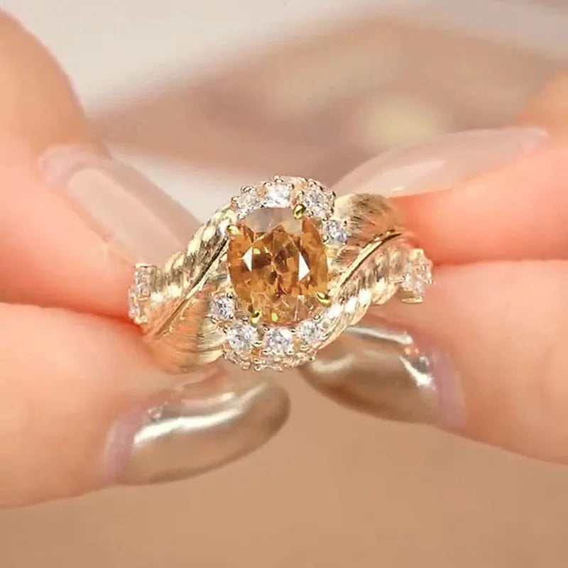 Copper women's ring with embossed feather design and yellow zircon stone in gold colour finish
