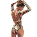 Women's backless one-piece swimsuit with leaf print pattern for swimming.