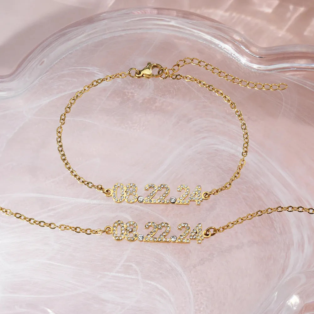Stainless steel digital bracelet with diamond-studded face on a wrist.