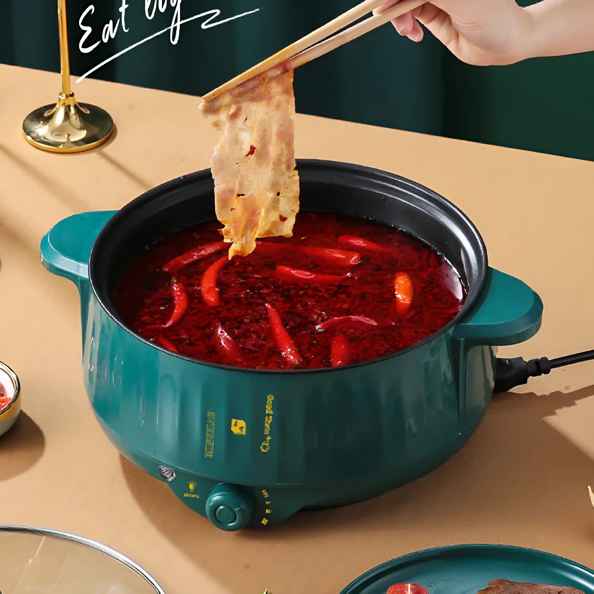 White electric hot pot with non-stick interior and UK plug on kitchen counter