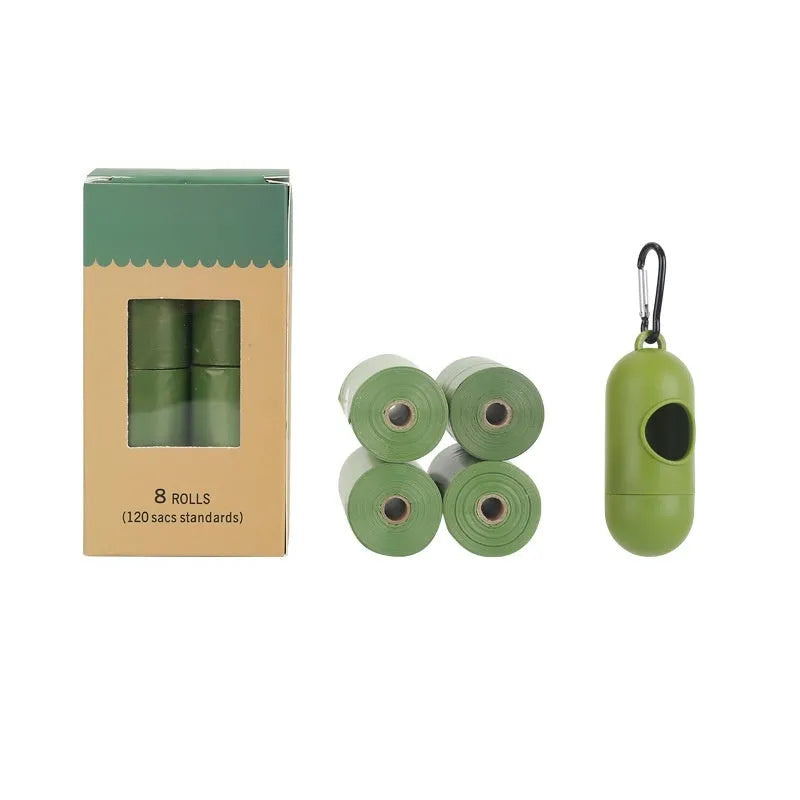 Roll of green EPI degradable dog poop bags next to a white dispenser on a table.