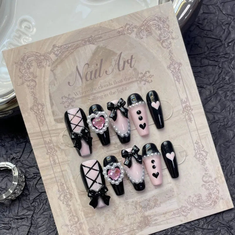Black peach heart hand-painted false nails with cat's eye style and bow patterns