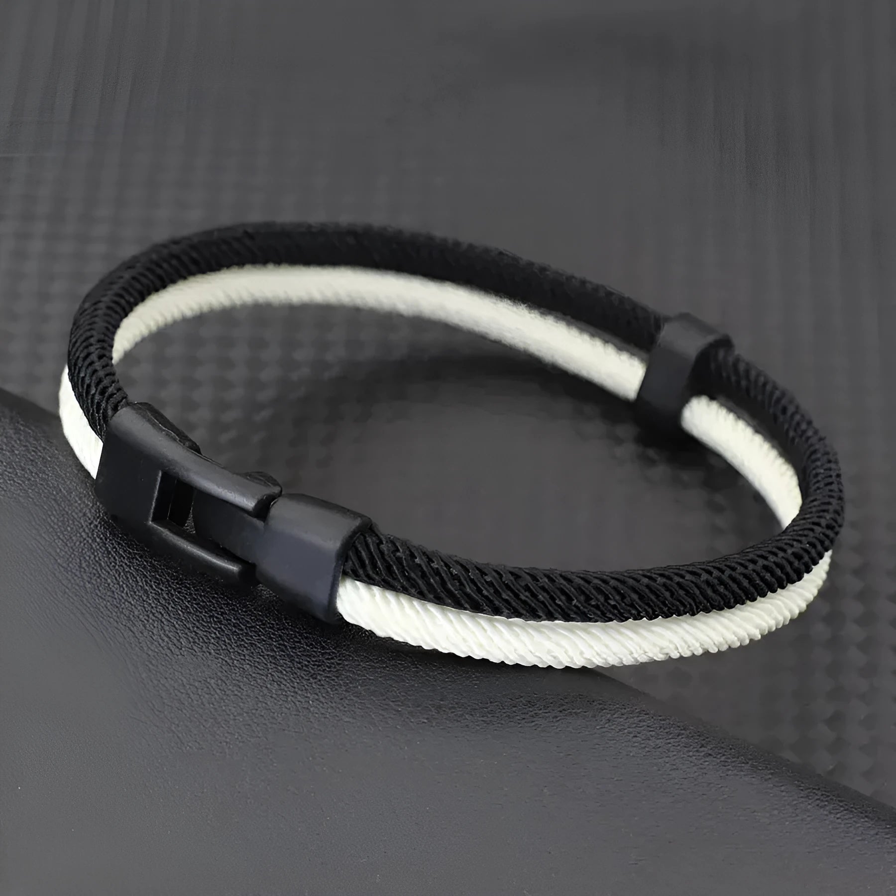 Handmade woven hand strap in Milan rope alloy showing black and white colour options