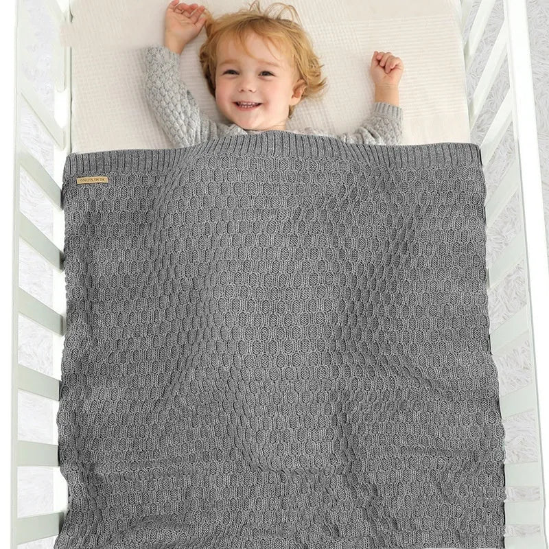 Infant hug blanket with three-dimensional lines in solid colours including pink and beige khaki